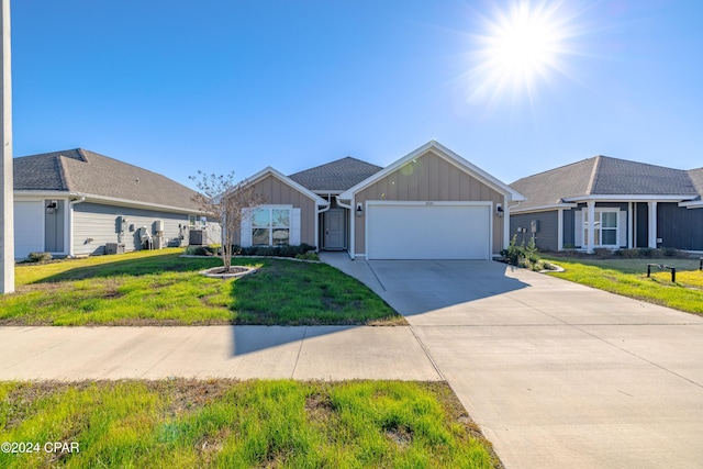 ranch-style home with a garage and a front yard