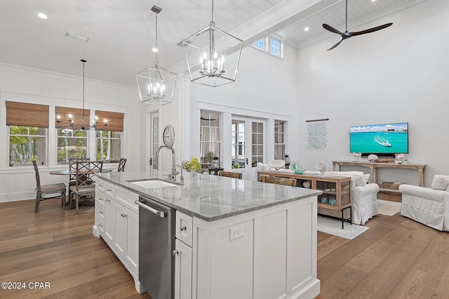 kitchen featuring light stone countertops, stainless steel dishwasher, ceiling fan, sink, and white cabinets