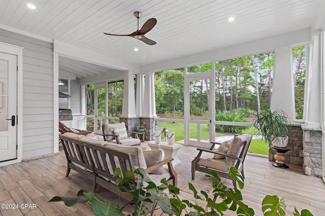 sunroom / solarium featuring ceiling fan