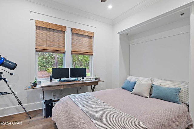 bedroom featuring hardwood / wood-style floors and crown molding