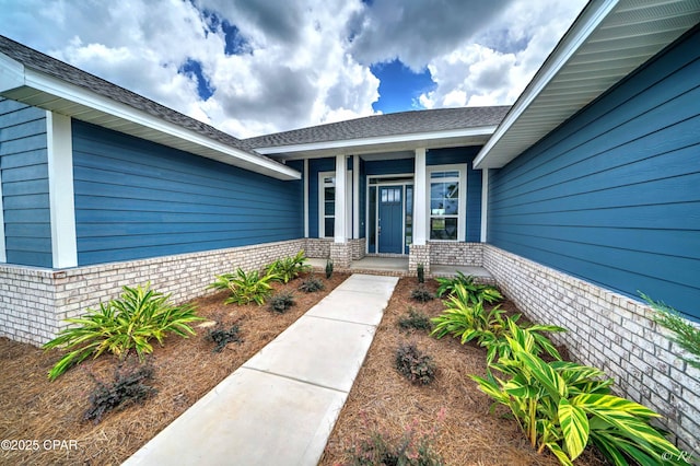 entrance to property with roof with shingles