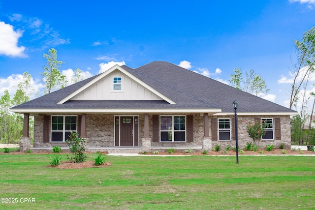 view of front of home featuring brick siding, board and batten siding, a shingled roof, and a front lawn