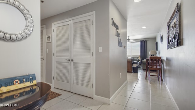 hall featuring light tile patterned floors