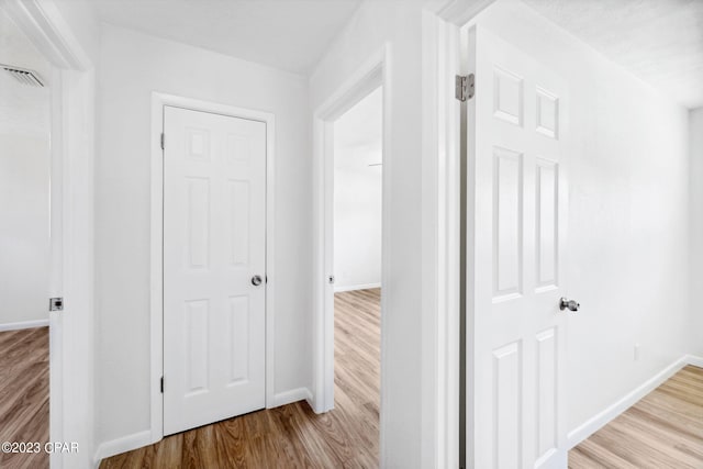 hallway with light wood-type flooring