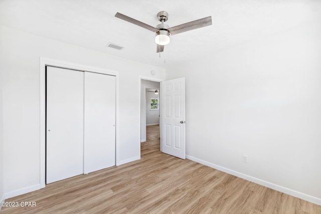 unfurnished bedroom featuring ceiling fan, a closet, and light hardwood / wood-style floors