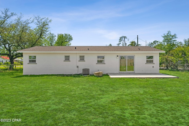 back of property featuring central AC unit, a patio area, and a lawn