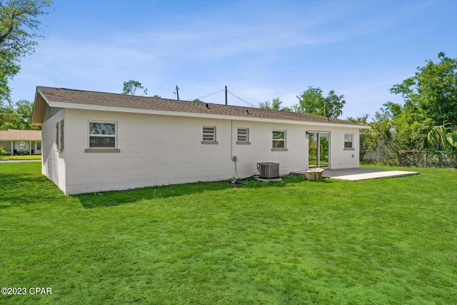 back of property featuring a lawn, a patio area, and central AC unit