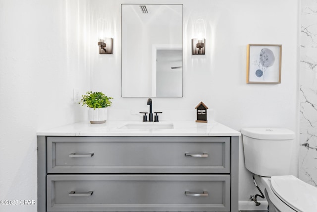 bathroom with vanity and toilet