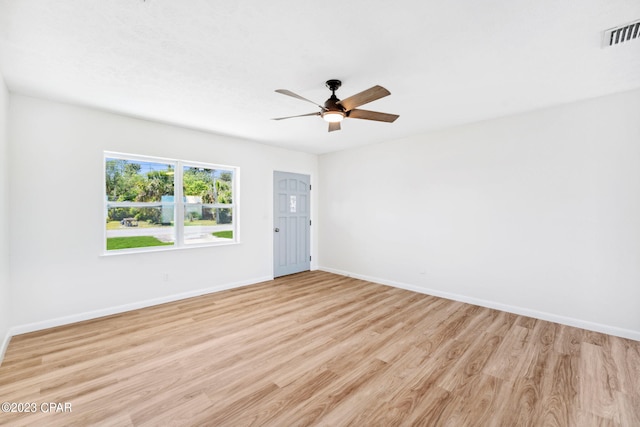 empty room featuring ceiling fan and light hardwood / wood-style flooring