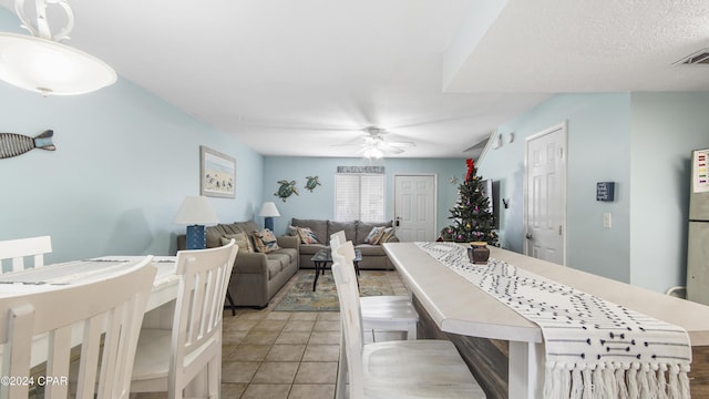 dining room featuring ceiling fan, light tile patterned flooring, and visible vents