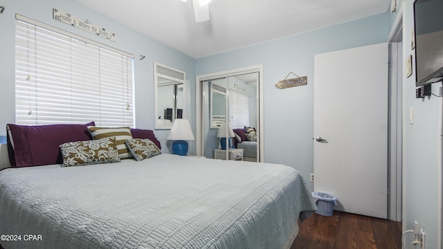 bedroom featuring a closet, wood finished floors, and a ceiling fan