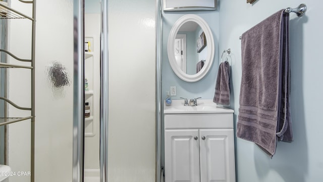 full bathroom with a shower stall and vanity