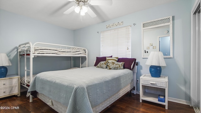 bedroom featuring a ceiling fan, baseboards, and wood finished floors