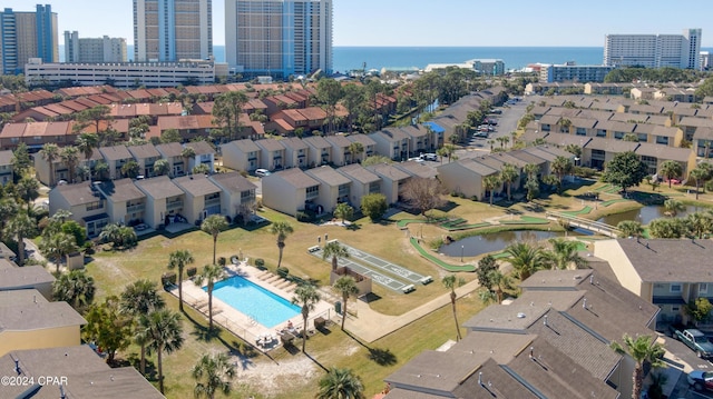 birds eye view of property featuring a water view and a city view