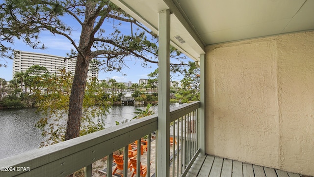 balcony with a water view and visible vents