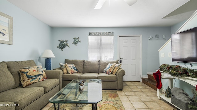 living area featuring light tile patterned floors and ceiling fan