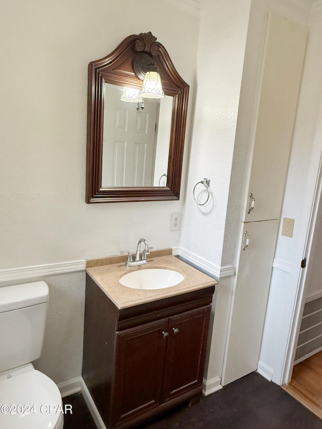 bathroom featuring vanity and toilet