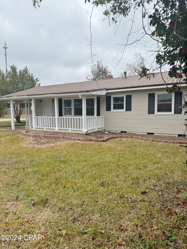 single story home with covered porch and a front lawn