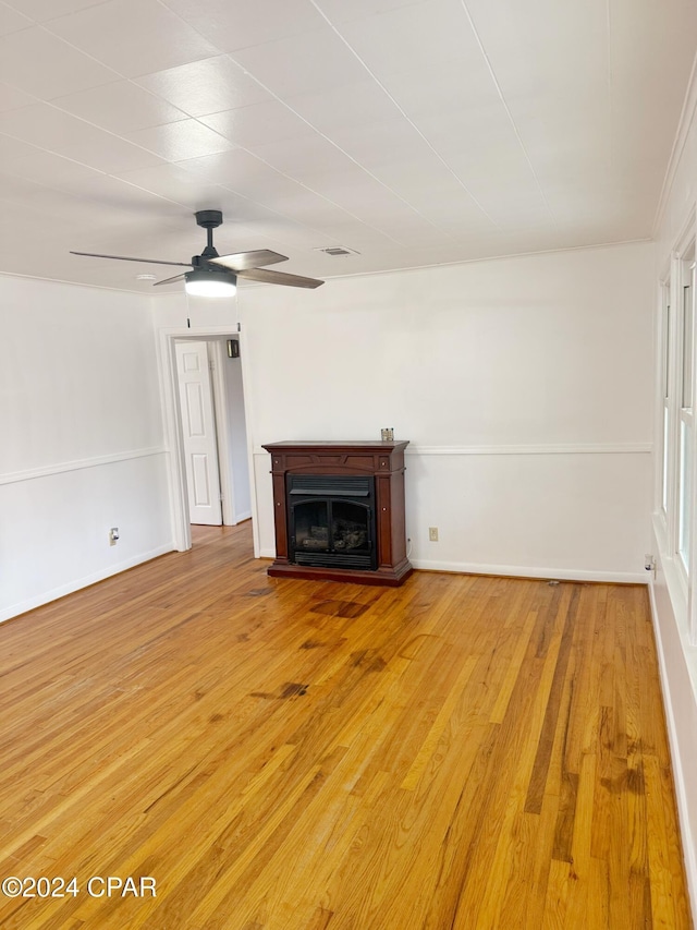 unfurnished living room featuring hardwood / wood-style floors and ceiling fan