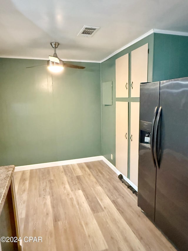 kitchen with stainless steel refrigerator with ice dispenser, light hardwood / wood-style floors, ceiling fan, and ornamental molding