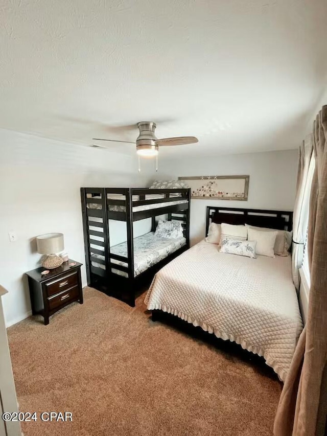 bedroom with ceiling fan and carpet