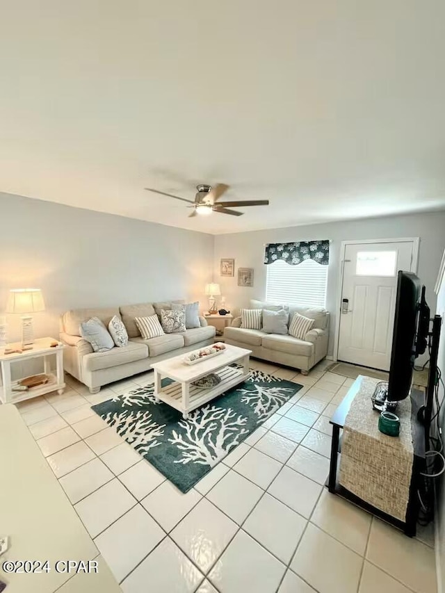 living room with light tile patterned floors and ceiling fan