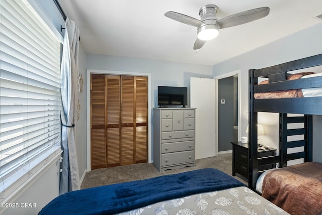 carpeted bedroom with a ceiling fan, visible vents, and a closet