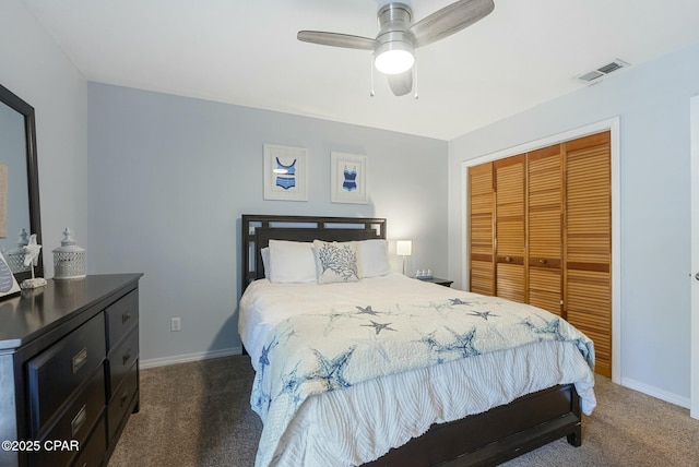 bedroom featuring ceiling fan, visible vents, baseboards, a closet, and dark carpet