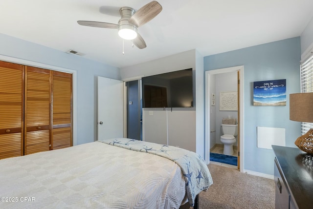 bedroom featuring visible vents, baseboards, a closet, carpet, and ensuite bath