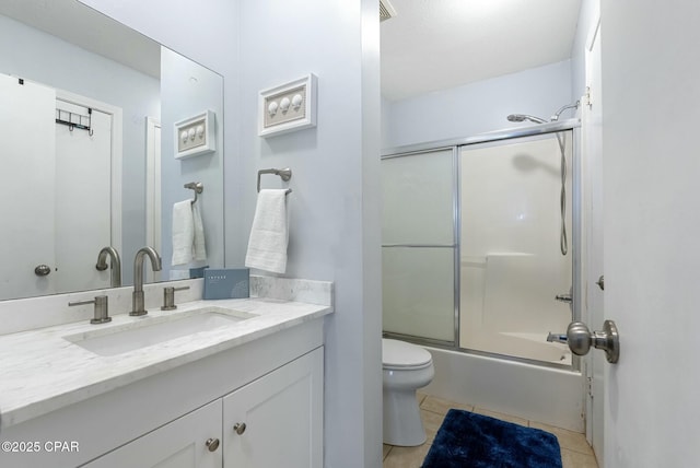 bathroom with toilet, tile patterned flooring, bath / shower combo with glass door, and vanity