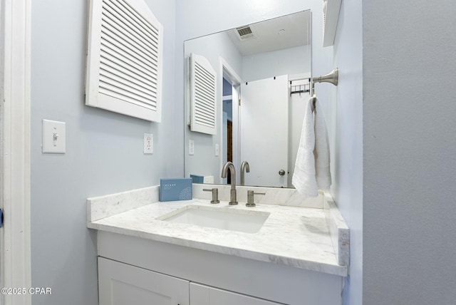 bathroom with visible vents and vanity