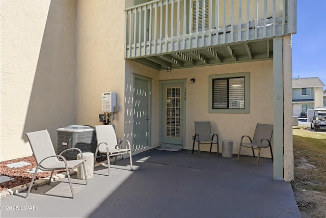 view of patio featuring central AC and a balcony