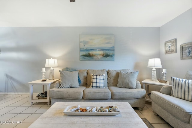 living area featuring baseboards and light tile patterned floors