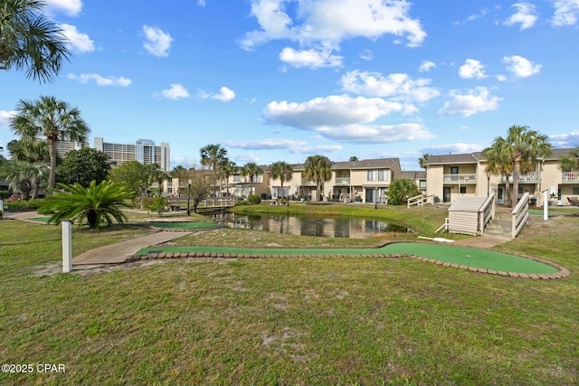 surrounding community featuring a residential view, a water view, and a lawn