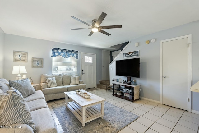 living room featuring baseboards, a ceiling fan, and light tile patterned flooring