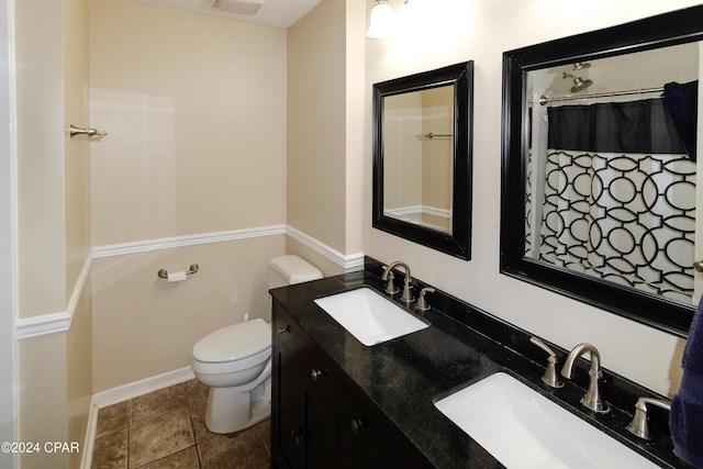 bathroom featuring toilet, a shower with shower curtain, vanity, and tile patterned flooring