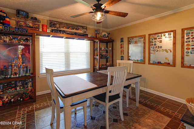 tiled dining area with ceiling fan, crown molding, and a textured ceiling