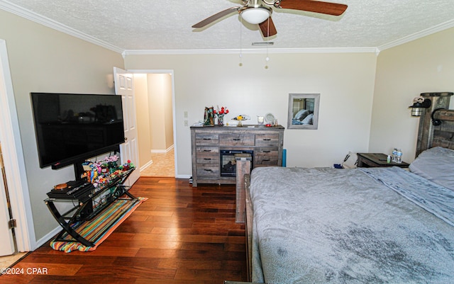 bedroom featuring a textured ceiling, ceiling fan, crown molding, and dark hardwood / wood-style flooring