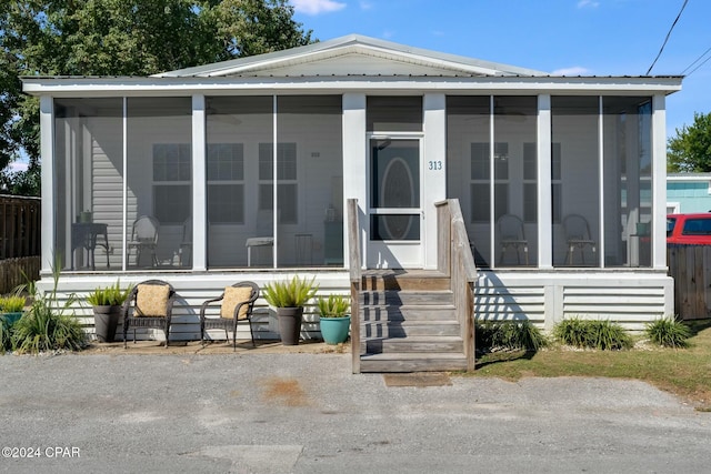 view of front of home featuring a sunroom