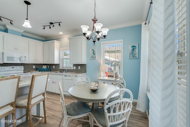 313 Laureno Pl, Panama City Beach, FL 32413 - kitchen featuring white cabinetry, white appliances, crown molding, and pendant lighting