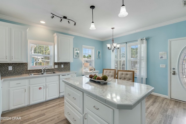 313 Laureno Pl, Panama City Beach, FL 32413 - kitchen with white cabinetry, white dishwasher, sink, and a kitchen island