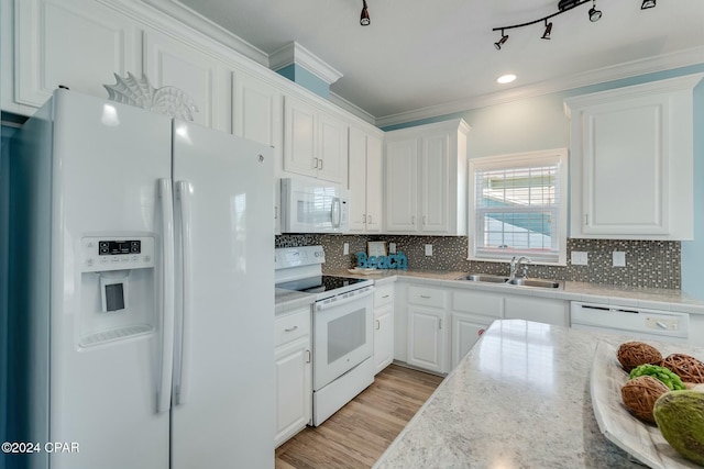313 Laureno Pl, Panama City Beach, FL 32413 - kitchen with sink, white appliances, rail lighting, ornamental molding, and white cabinets