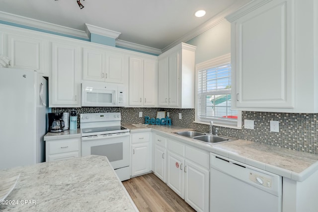 313 Laureno Pl, Panama City Beach, FL 32413 - kitchen featuring sink, white cabinets, and white appliances