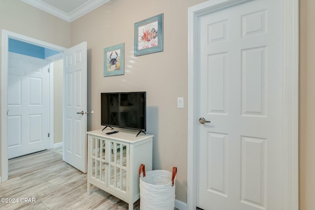 313 Laureno Pl, Panama City Beach, FL 32413 - bedroom with a crib, ornamental molding, and light wood-type flooring