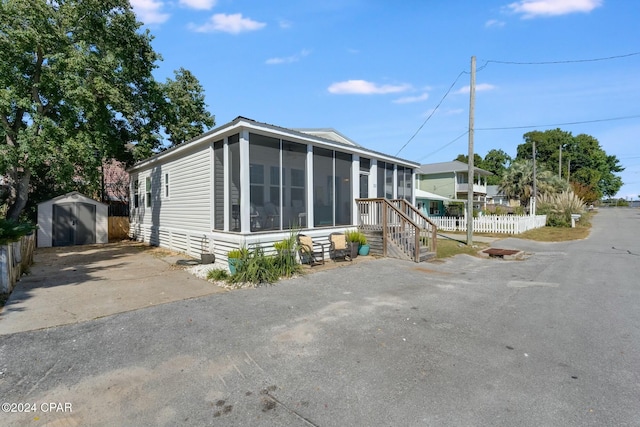 manufactured / mobile home featuring a shed and a sunroom