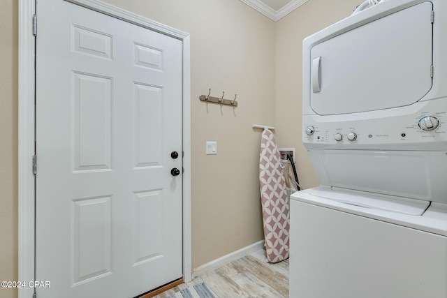 313 Laureno Pl, Panama City Beach, FL 32413 - washroom with stacked washer / drying machine, crown molding, and light hardwood / wood-style flooring