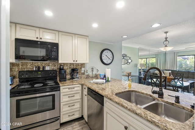 kitchen featuring cream cabinetry, appliances with stainless steel finishes, tasteful backsplash, and sink