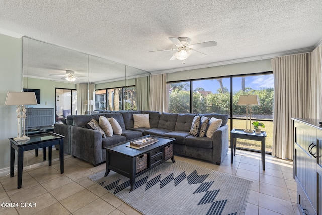 living room featuring ceiling fan, light tile patterned floors, and a textured ceiling