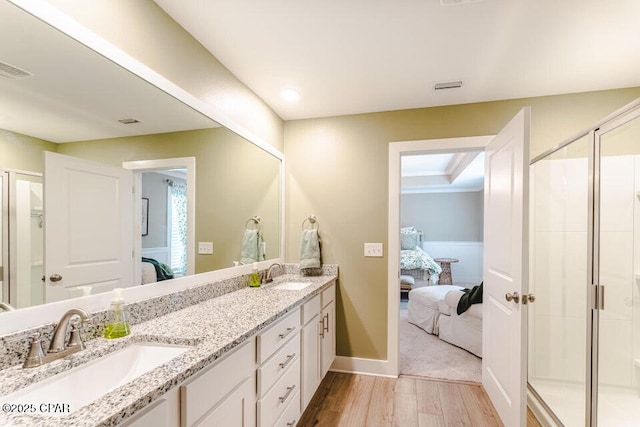 bathroom featuring vanity, an enclosed shower, and hardwood / wood-style flooring