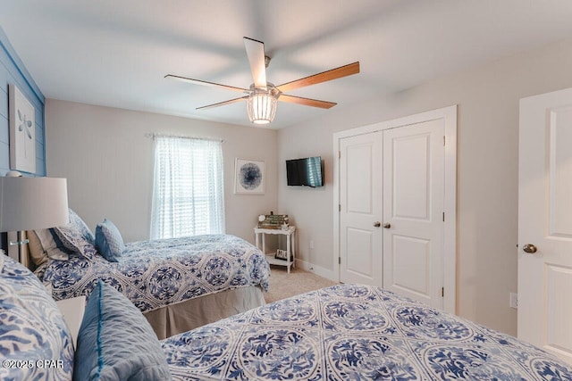 bedroom with carpet flooring, ceiling fan, and a closet